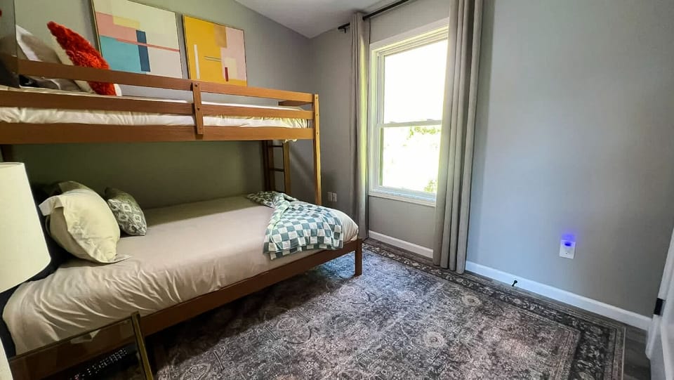 Gather the crew in this cozy room with stylish bunk beds and a bright window view. Perfect for families or friends looking to share memories together in comfort and modern design.