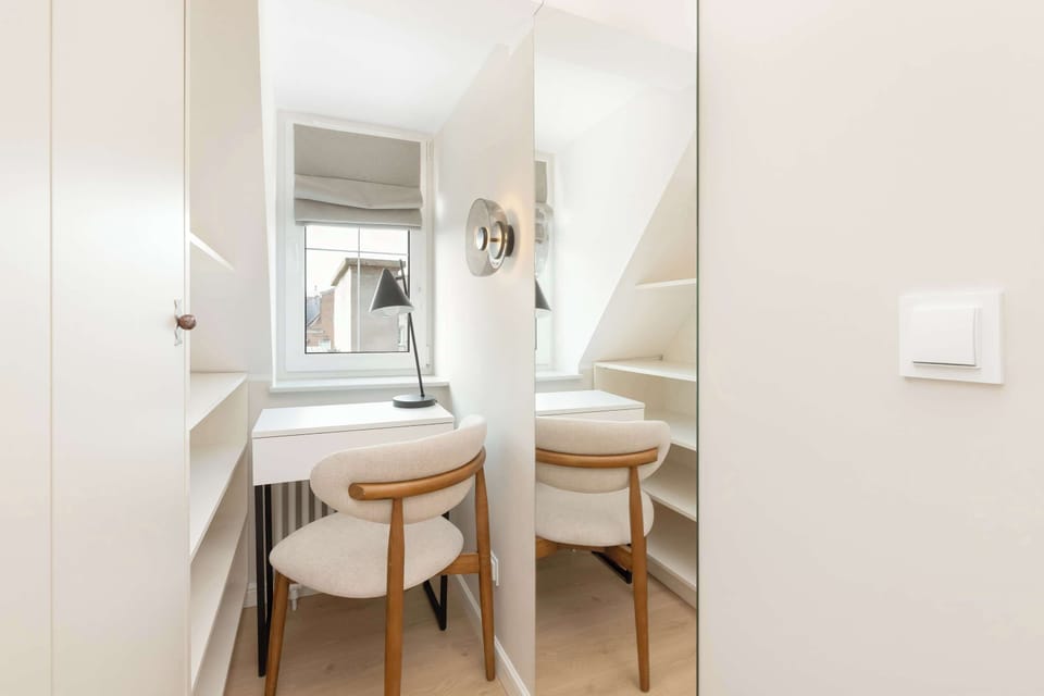 A compact wooden desk provides a practical workspace for remote work, studying, or planning the day's activities in a quiet setting.