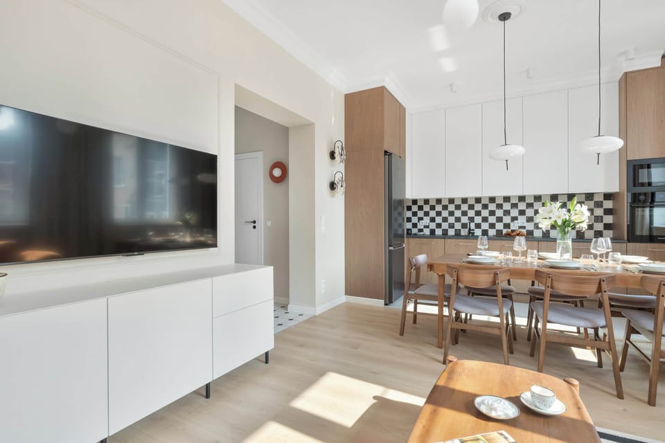 A hallway connecting the apartment's living spaces, with light-colored flooring and modern finishes creating a welcoming entrance.