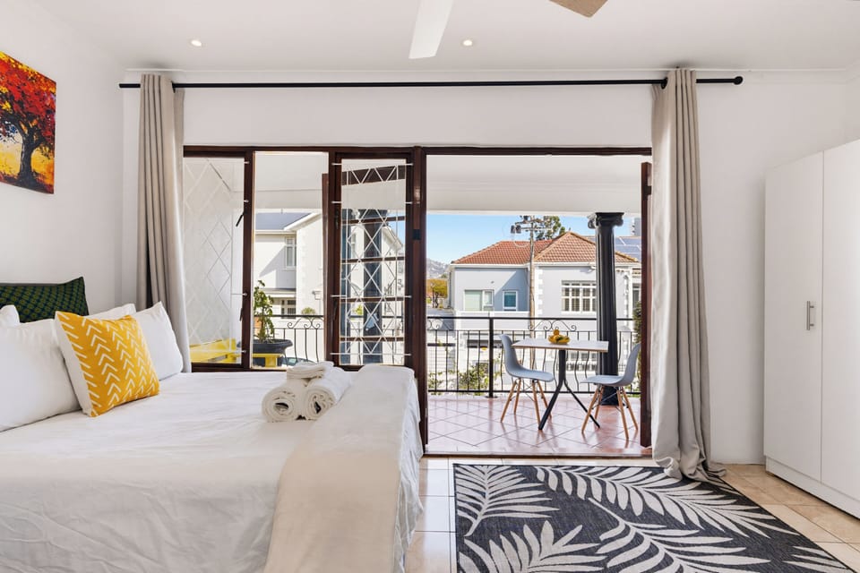 Bright bedroom with private balcony and charming outdoor seating