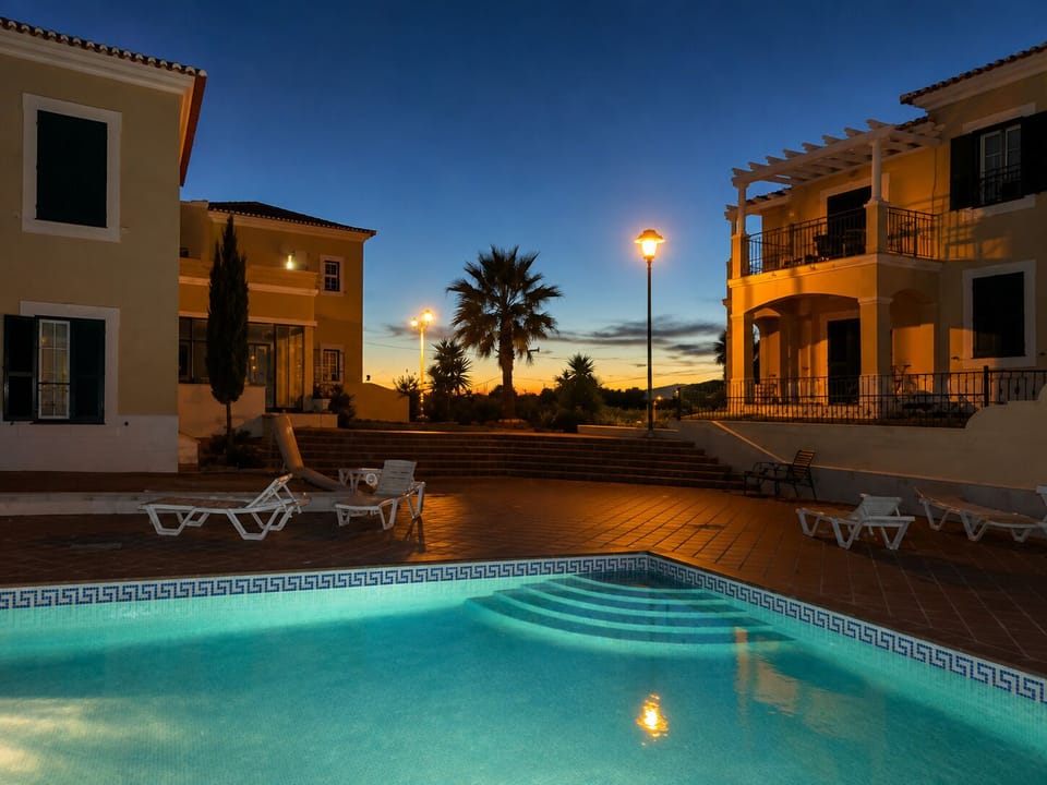 The golden hour at the main pool, enjoy it from the balcony with a glass of wine