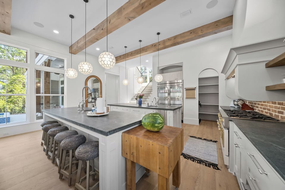 Dark countertops and modern appliances blend perfectly with warm wood tones, creating your ideal cooking and entertaining space.