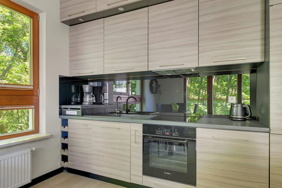 Deluxe Apartment, Balcony | Private kitchen | Highchair, dining table