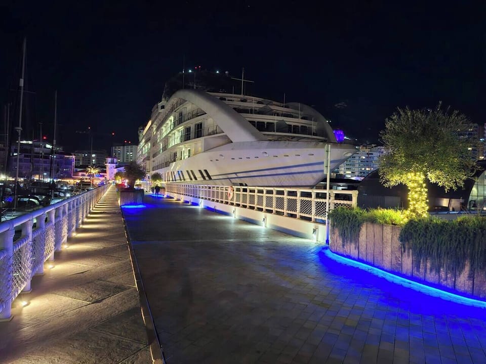 Experience the magic of Ocean Village at night. Stroll along the illuminated promenade right outside your door, with the glowing Sunborn Superyacht and vibrant nightlife just steps from Marina Club. Luxury living, day and night.