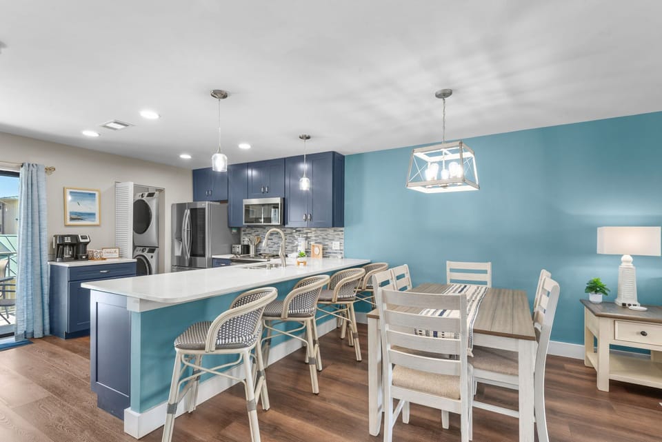 Step into your bright, open kitchen and dining space. Gather around the island, perfect spot for morning coffee or evening meals.