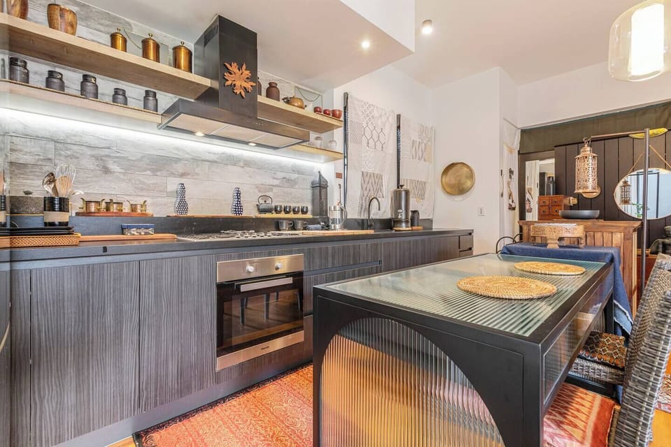 The sleek kitchen offers modern appliances like an oven, stovetop, microwave, dishwasher and Nespresso machine, complemented by thoughtful touches that create a convenient space to cook, create and gather.