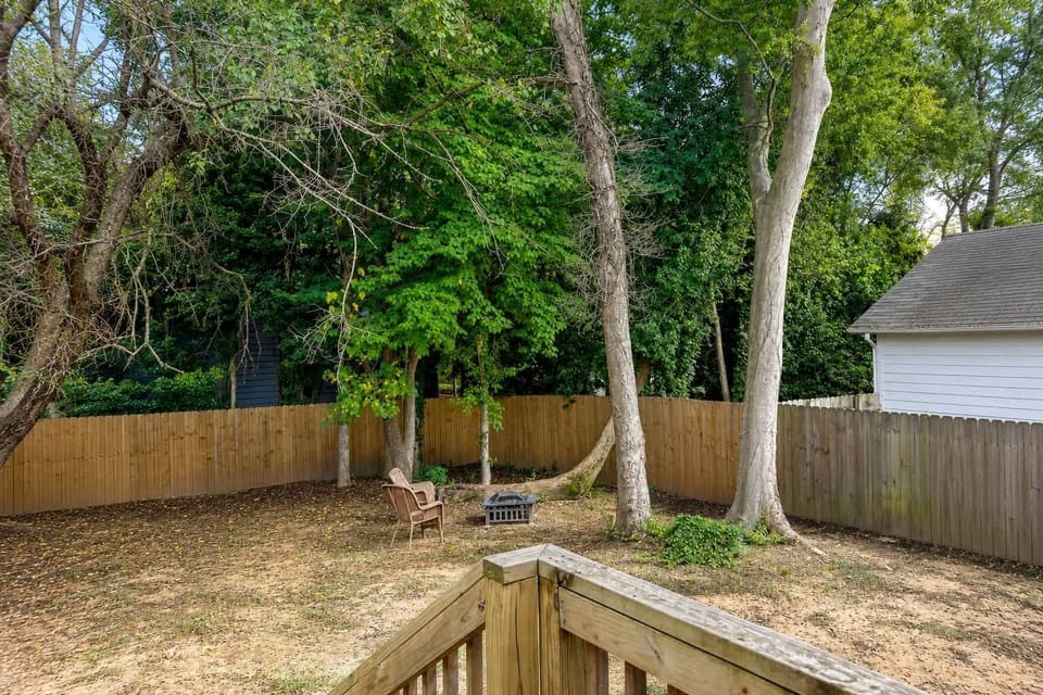 Big fenced backyard under mature trees