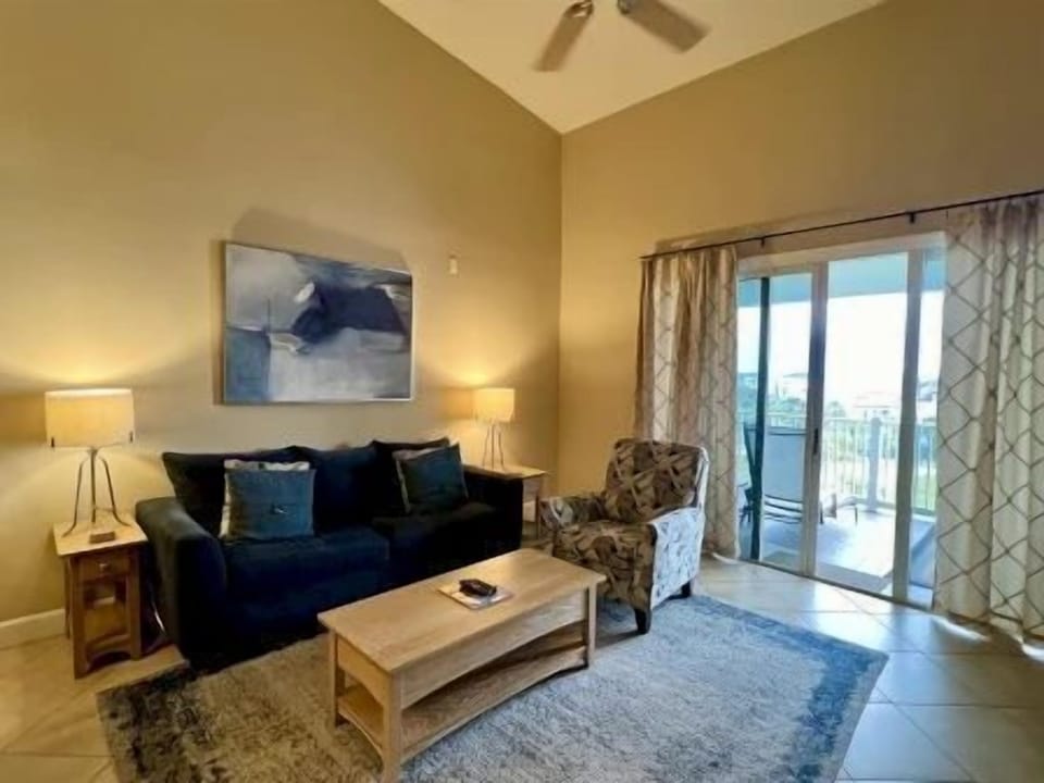 Second living space with sun-lit seating and coastal tones throughout