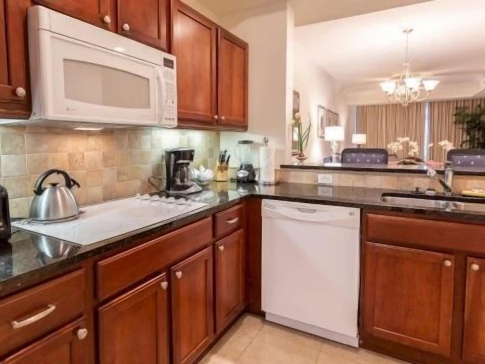 Kitchen with rich wood cabinetry, granite counters, and a full set of stainless appliances