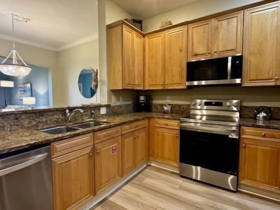 Kitchen with granite counters, stainless steel appliances, and a two-seat kitchen bar