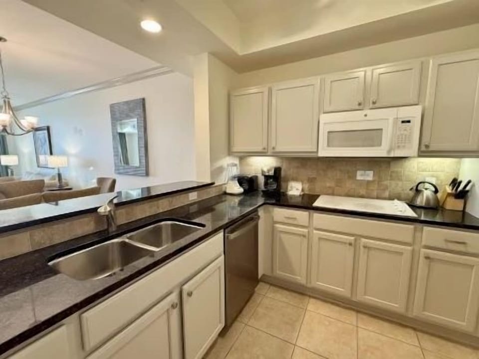 Kitchen with modern cabinetry, granite counters, and full-sized appliances for group cooking
