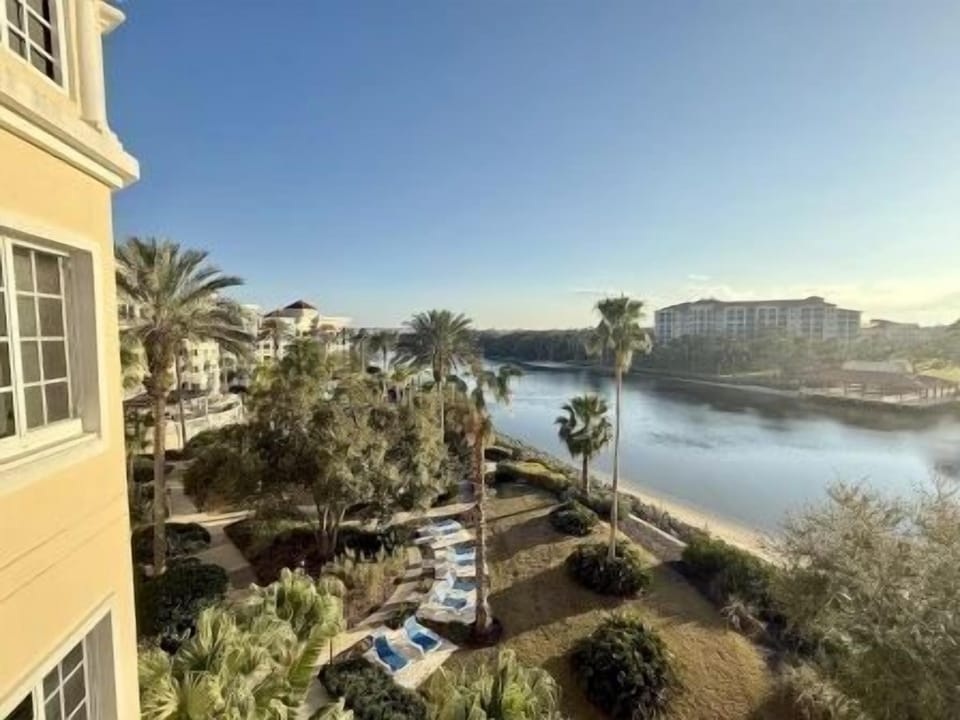 Balcony view overlooking the Intracoastal waterway with palms and green surrounds below