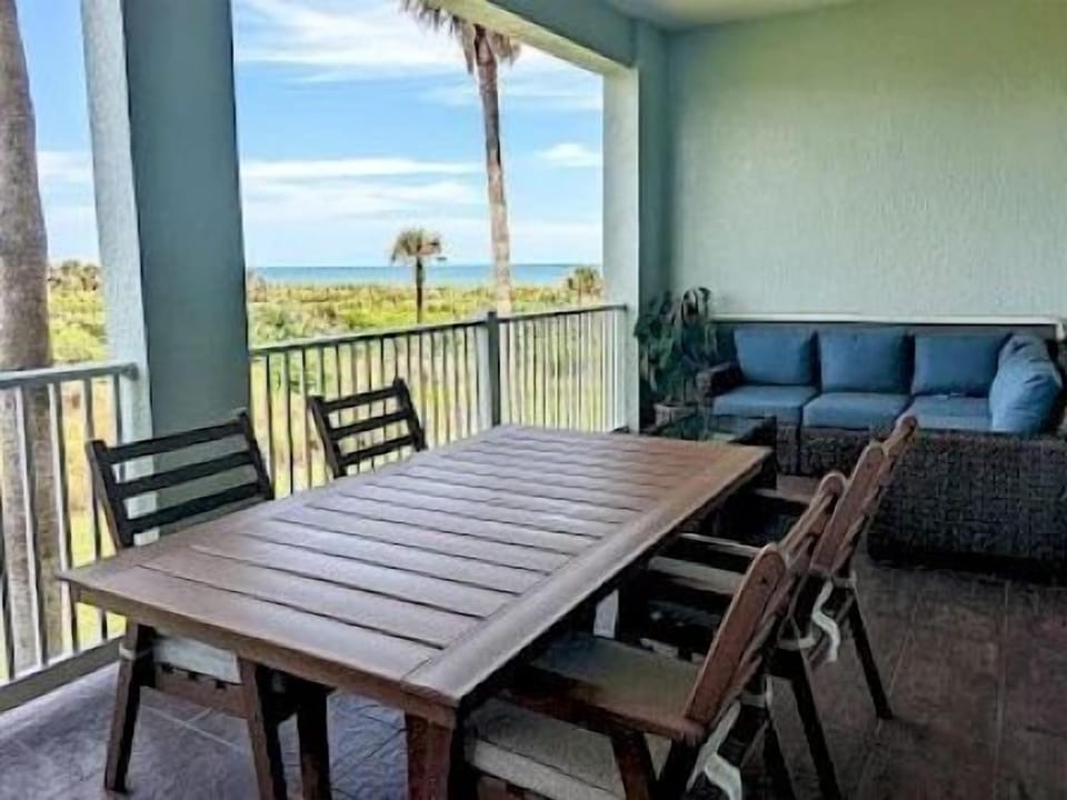 Private balcony with seating overlooking the ocean and golf course — morning coffee here never gets old