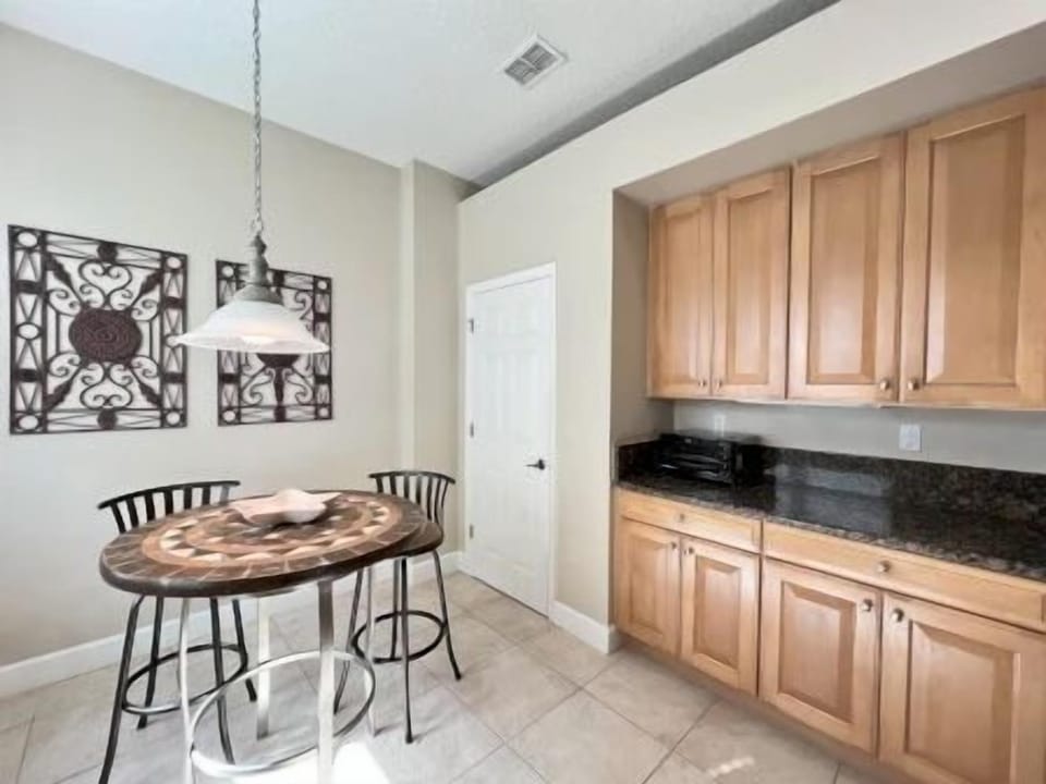 Round dining table beside a bright window — a good spot for breakfast or casual group meals