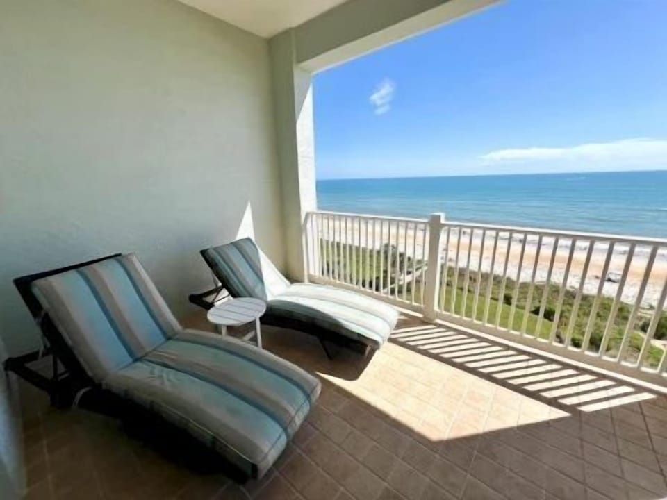 Private balcony with two chairs — open ocean views and room to put your feet up