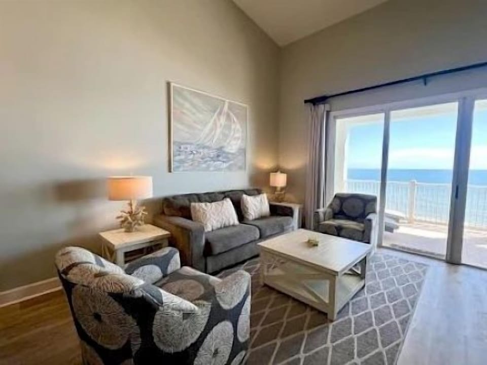 Living area with ocean views framing the windows — a bright and open space for the group