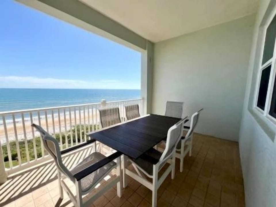 Balcony table with ocean views and a sea breeze — evenings out here don't need much else