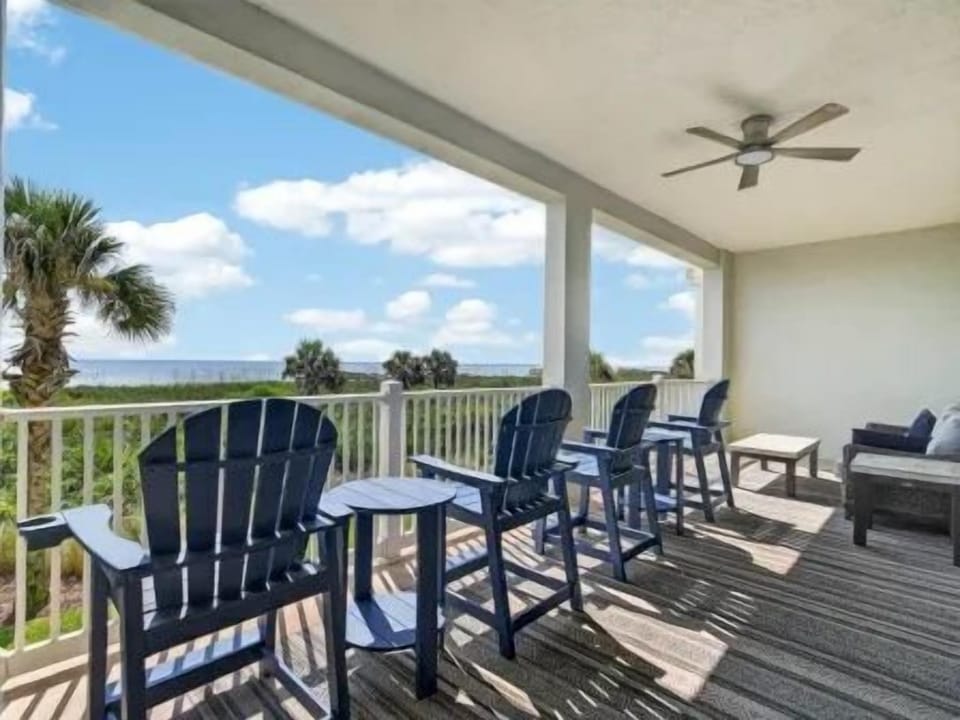 Private balcony with cushioned seating overlooking the ocean — a good spot for morning coffee