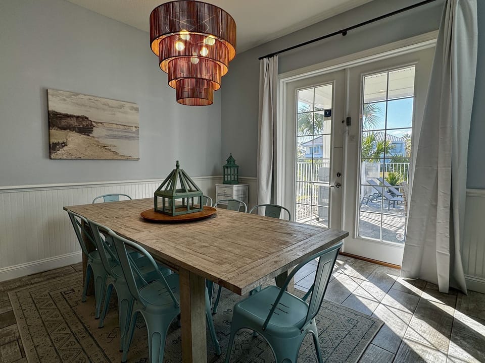 Dining area with table seating for the group, open to the kitchen and lanai