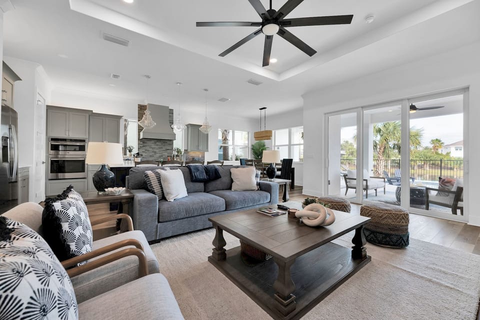 Light-filled living area with comfortable seating and an electric fireplace for cool evenings