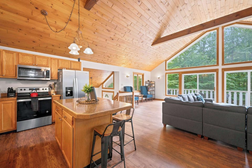 The kitchen opens right onto the living area, with counter seating for four and a clear view through to the sliding doors and deck beyond.