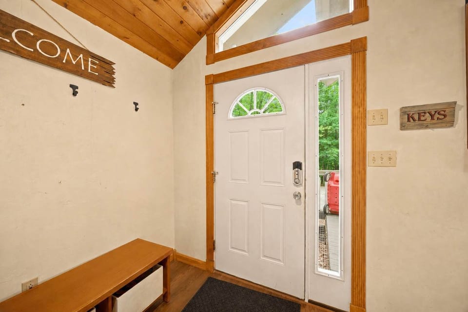 The foyer has bench seating and wall hooks for shoes and gear right inside the door.