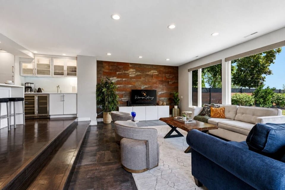 This wide view shows the main level’s open flow from kitchen to dining and living areas.