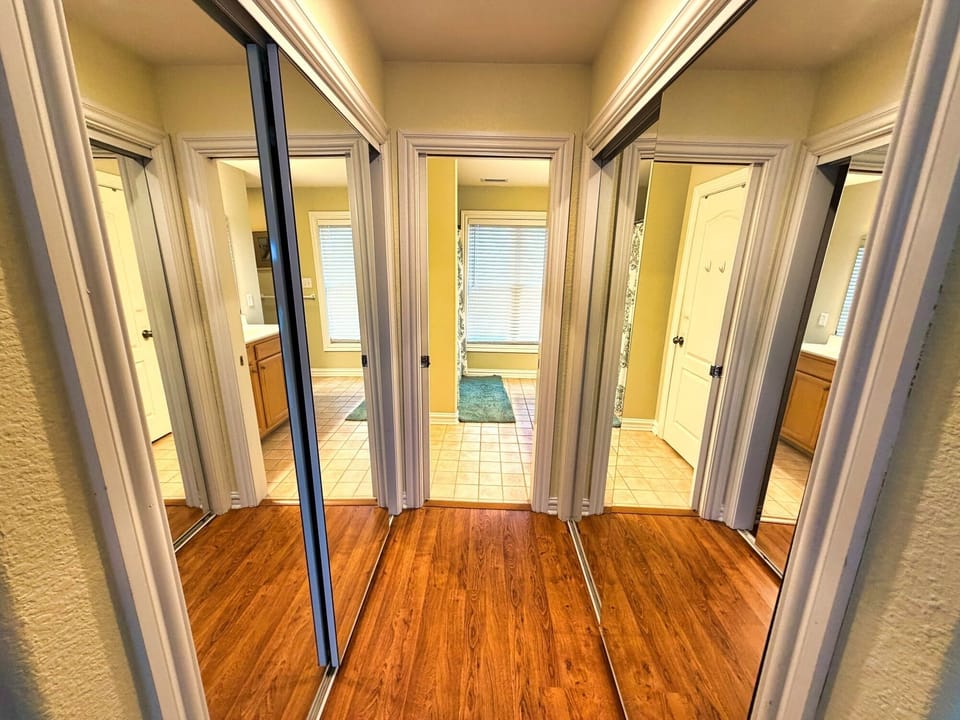 Bright hall with mirrored closets and easy access to bedrooms/baths