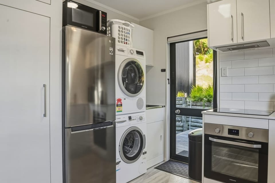 The laundry is cleverly tucked into the kitchen with a full washer and dryer. 