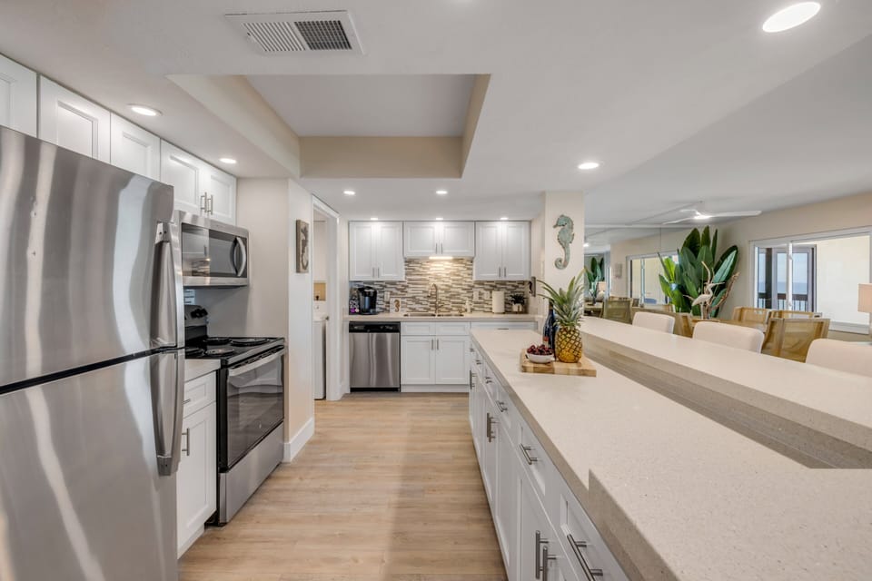 Featuring ample counter space, this kitchen offers plenty of room for meal prep, entertaining, and enjoying the ease of everyday coastal living