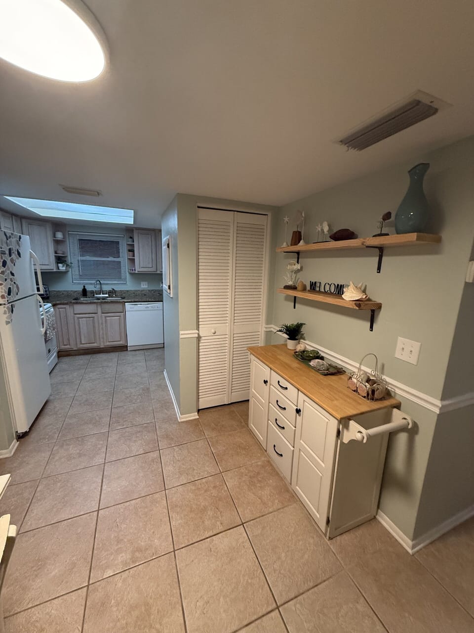 Bright tiled entry with stylish storage and a clean, functional layout
