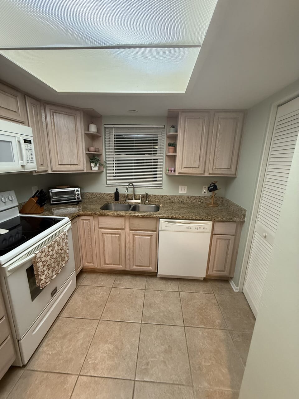 Bright, fully equipped kitchen with ample counter space and clean modern finishes