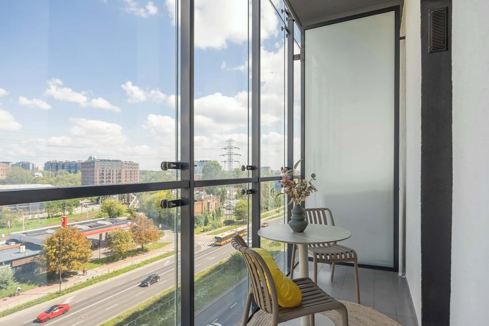 Private balcony with outdoor seating and scenic city views.