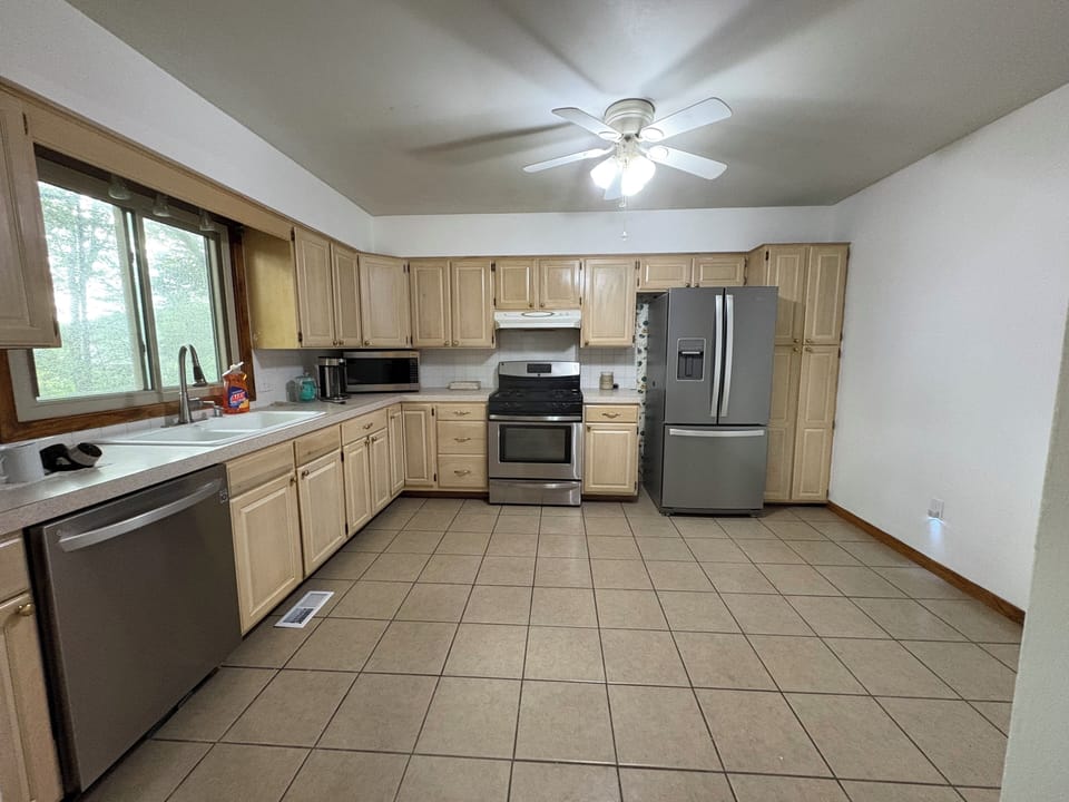 A full kitchen w/full size refrigerator, dishwasher, gas range, and microwave.