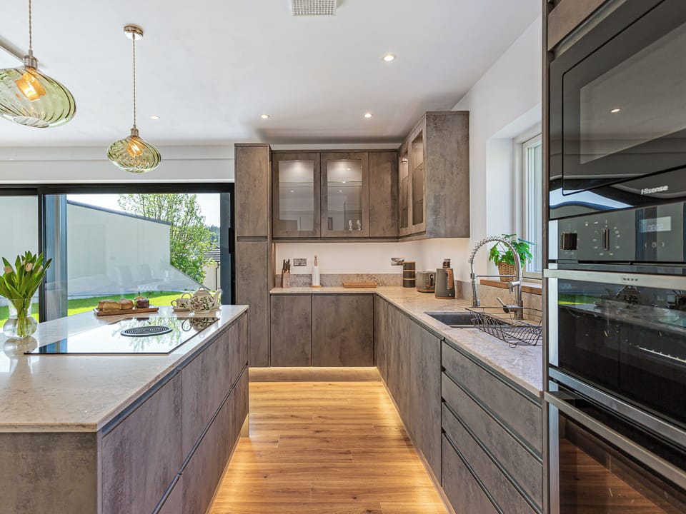 Sleek built-in ovens and warm under-cabinet LED lighting.