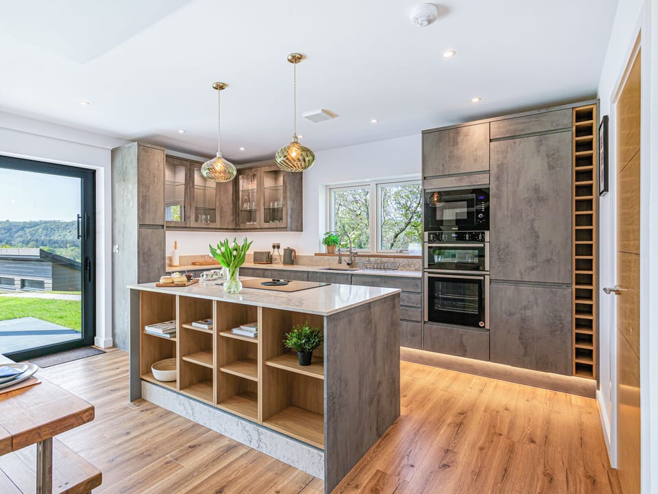 High spec luxury kitchen featuring a central island and modern appliances.