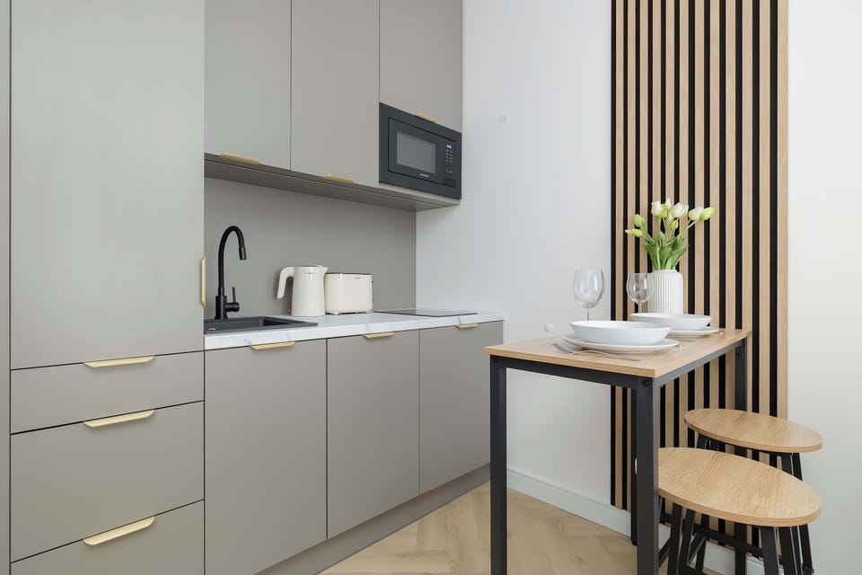 A modern kitchenette with everything you need to prepare meals during your stay. A small dining area provides a comfortable place to enjoy breakfast or dinner.