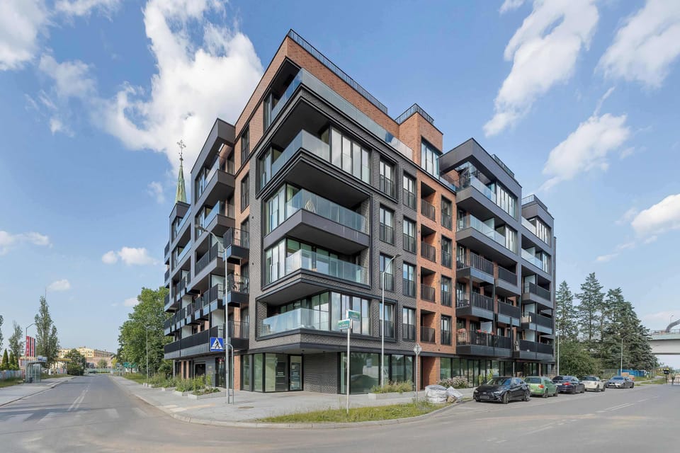 A modern apartment building with elegant architecture and spacious balconies. The property offers a contemporary setting in a well maintained neighborhood.