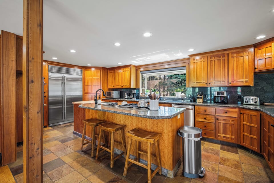 Gather around the beautifully crafted wood island and start your day with fresh coffee. Natural light pours through the window while you prepare meals with stainless appliances and ample counter space—perfect for your culinary adventures.