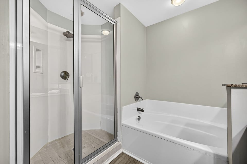 Your private bathroom features a spacious walk-in shower with glass enclosure, plush towels at the ready, and modern fixtures throughout for a relaxing, refreshing experience.