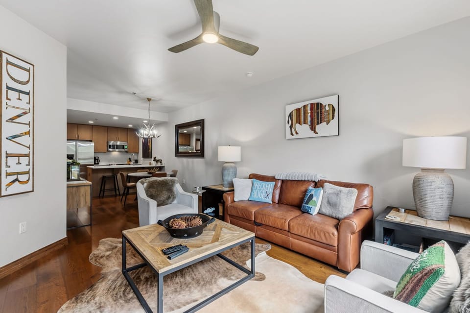 Settle into your modern open-concept living space, where rich leather seating and mountain-inspired accents create a warm, inviting atmosphere perfect for unwinding after a day of adventure.