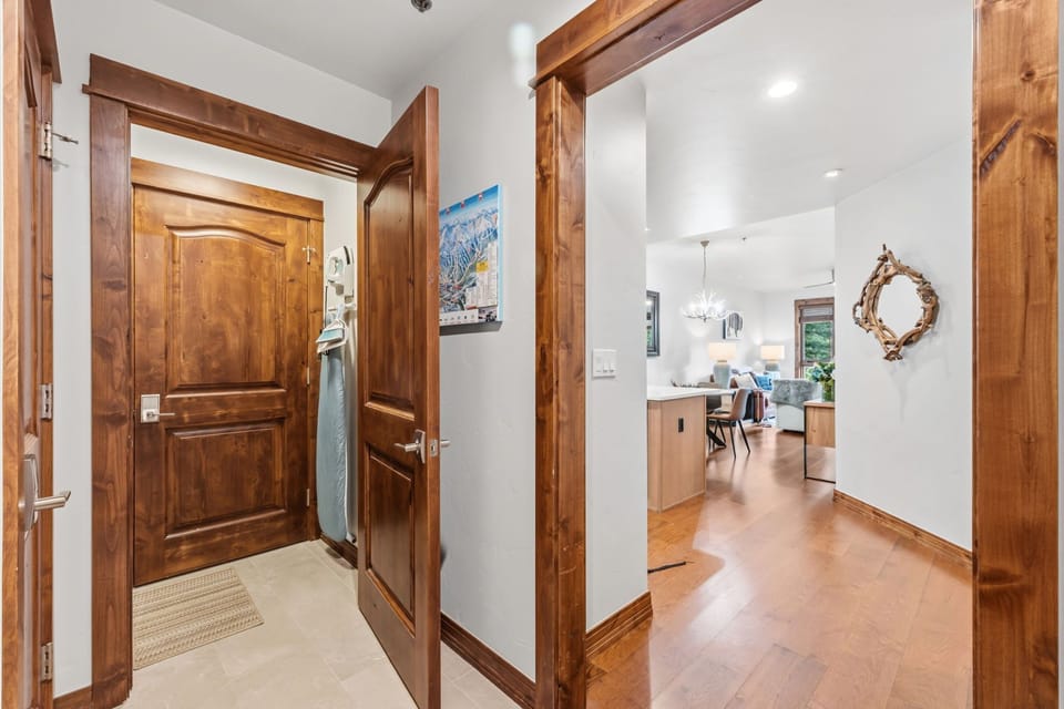 Step through your private entrance into a welcoming hallway where rich wood tones and warm lighting set the tone for your mountain retreat.