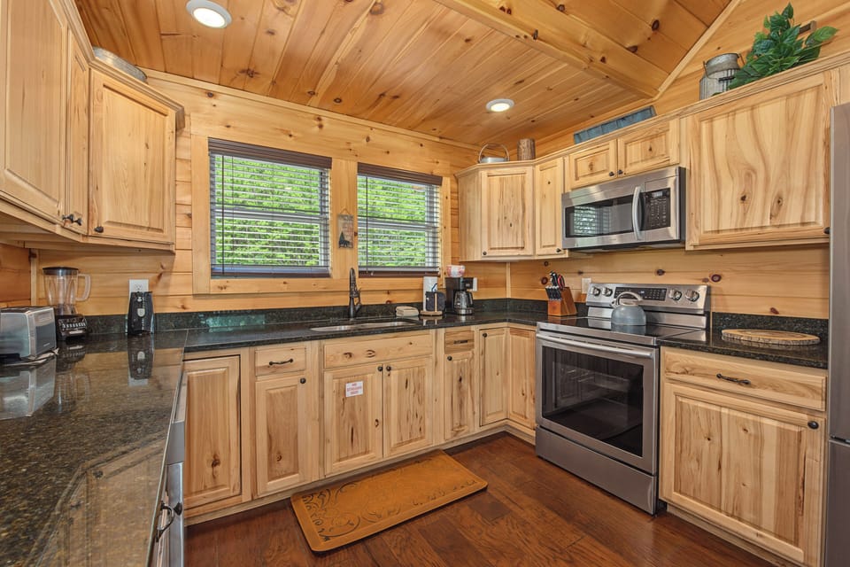 Step into your cozy mountain kitchen, where warm wood tones and all the comforts of home await. Prepare meals surrounded by rustic charm, complete with modern appliances and plenty of counter space—perfect for morning coffee or evening gatherings.