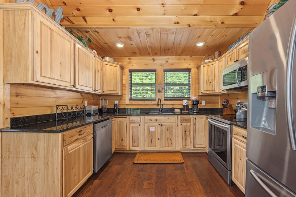 Your fully equipped mountain kitchen features warm wood cabinets, granite counters, and all the stainless steel appliances you need to whip up home-cooked meals during your stay.