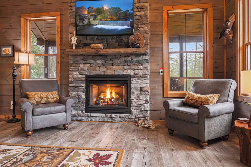 Sink into plush armchairs beside the crackling fireplace, where warm wood tones and natural stone create your perfect mountain retreat. Enjoy streaming your favorites on the flat-screen TV after a day of exploring.