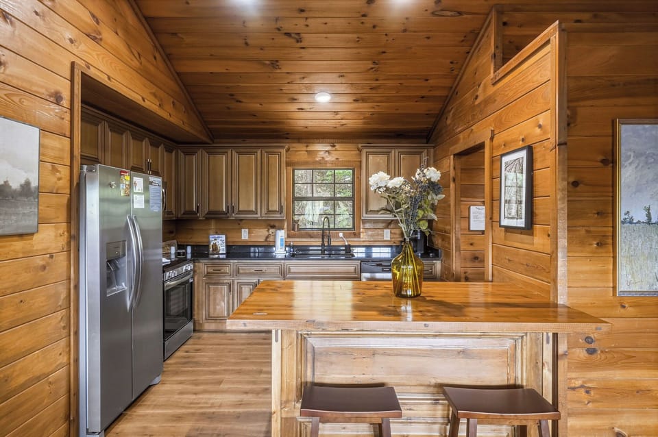 Your fully-equipped kitchen features warm wood finishes, modern appliances, and plenty of counter space for meal prep. Natural light and a welcoming island make this the perfect spot to gather.