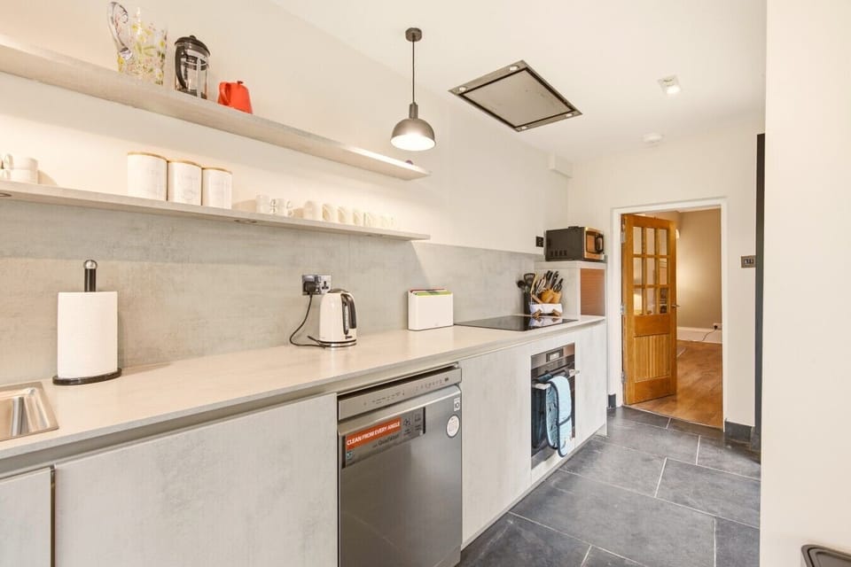 Sleek contemporary kitchen with integrated appliances and generous workspace.