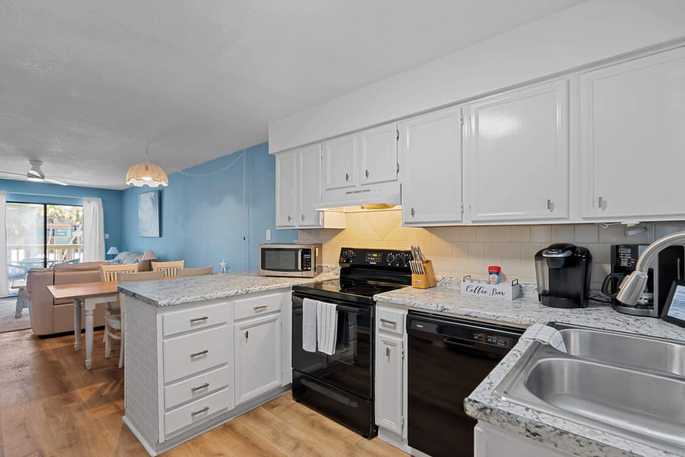 The open kitchen keeps the cook connected with everyone relaxing in the living and dining areas.