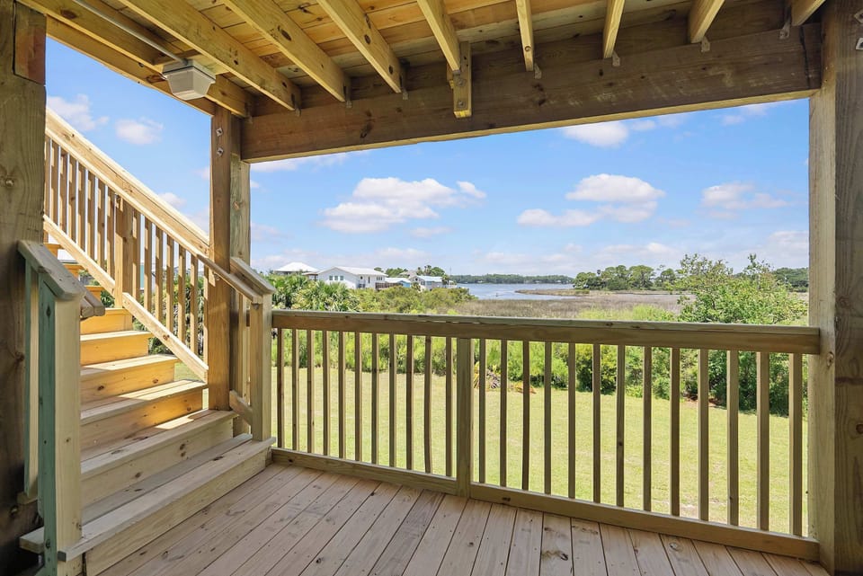Exterior walkways provide views toward the natural lagoon-side landscape.