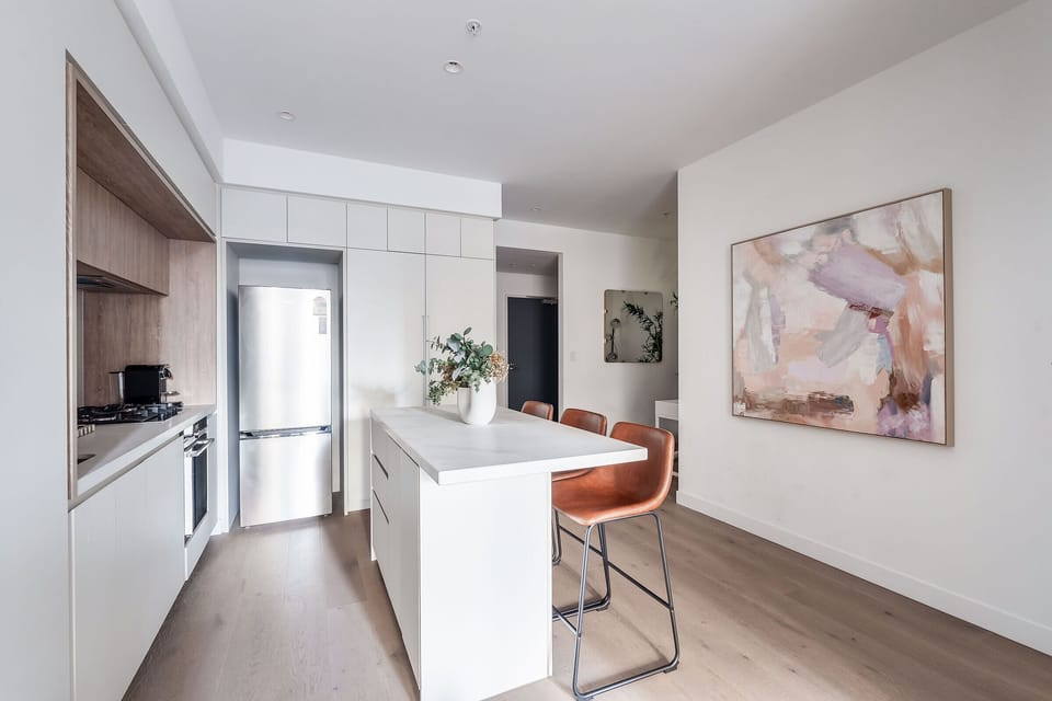 Prepare meals in the sleek kitchen, where a gas cooktop, oven, fridge and cooking essentials make dining at home simple and convenient.